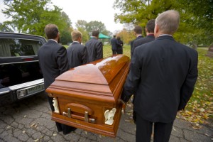 Carrying-casket-to-grave-300x200